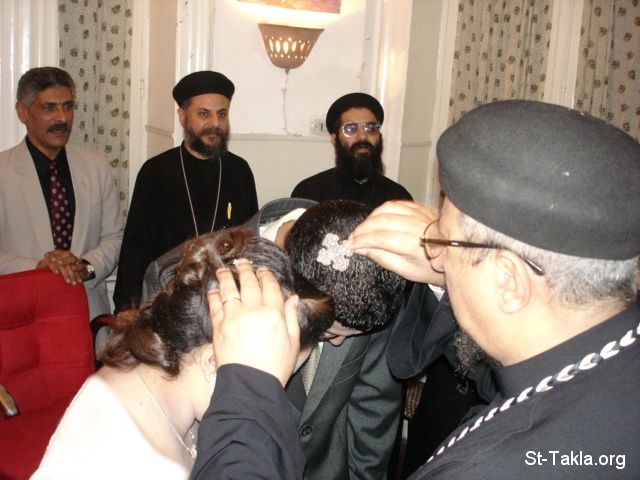 St-Takla.org Image: Coptic Engagement, a priest praying for the newly engaged - put with permission from the couple - Photograph by Michael Ghaly for St-Takla.org, 2007     :    ɡ ɡ      -      -    :   ǡ 2007